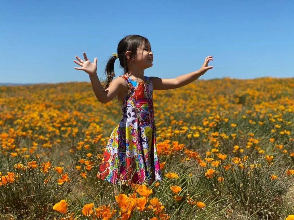 Girl in a field of orange poppies