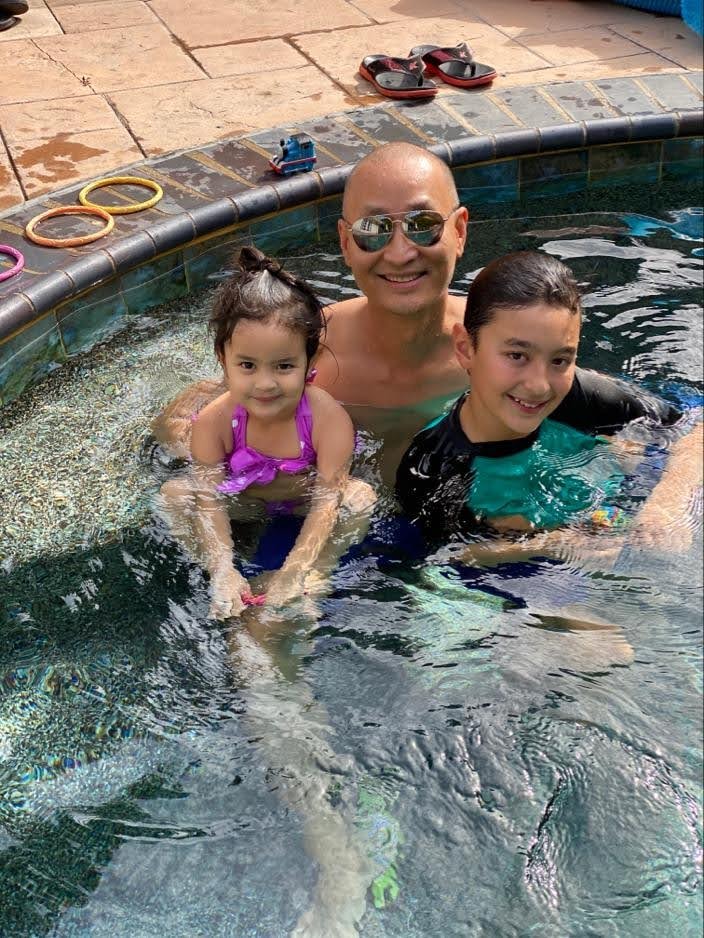 Dad and two kids swimming in the pool